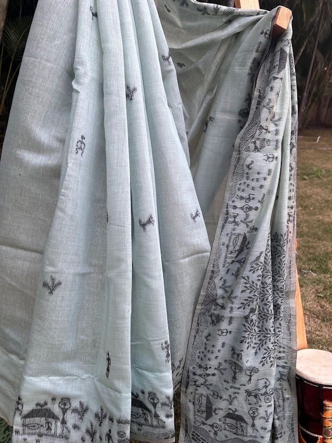 A sea blue earthy shade with warli art cotton saree